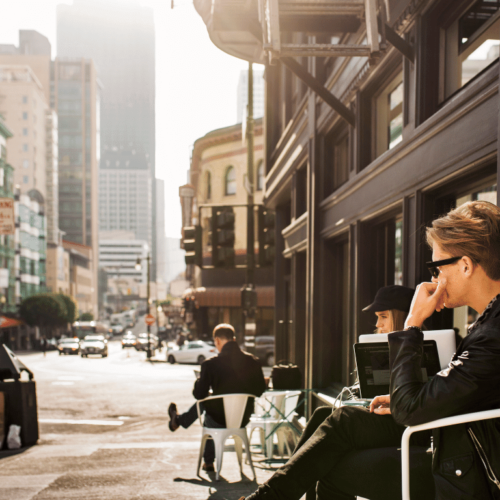 young-man-and-woman-sitting-by-coffee-shop-with-la-Mixed-Use-Property