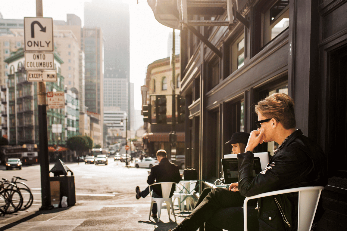 young-man-and-woman-sitting-by-coffee-shop-with-la-Mixed-Use-Property